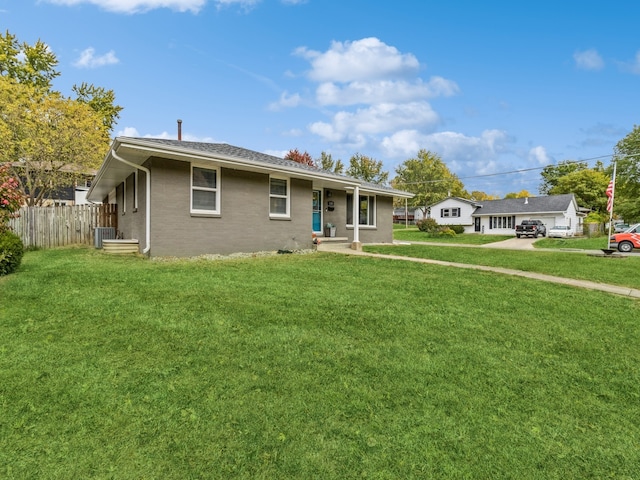 view of front of property with central AC and a front lawn