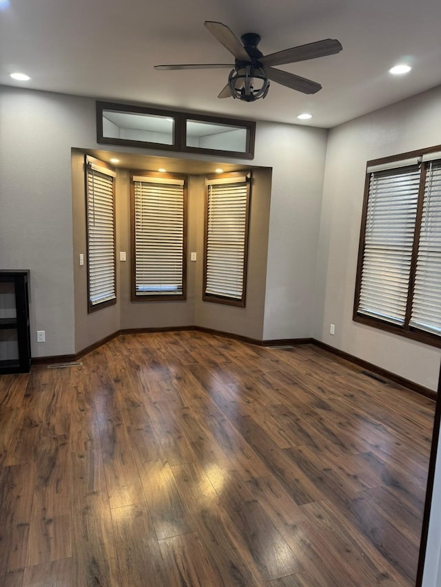 unfurnished room featuring ceiling fan and dark hardwood / wood-style flooring