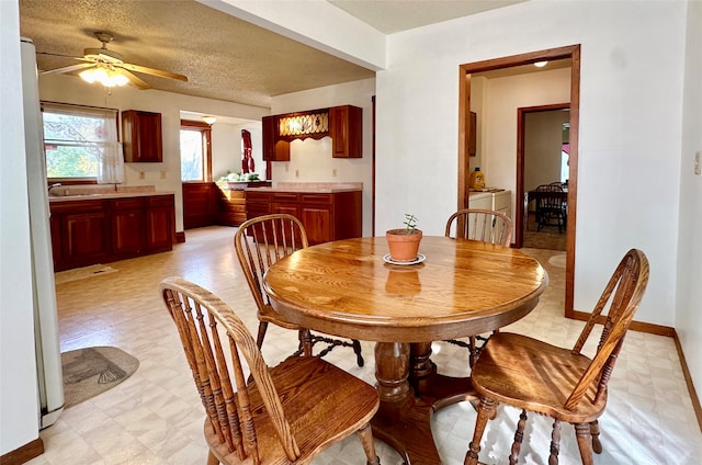 dining area featuring a textured ceiling and ceiling fan