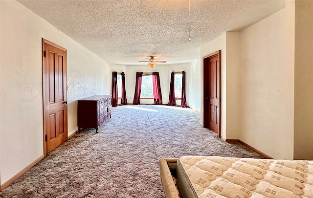 corridor featuring carpet and a textured ceiling