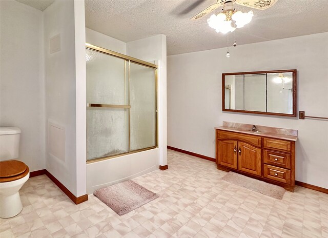 full bathroom with ceiling fan, enclosed tub / shower combo, toilet, vanity, and a textured ceiling