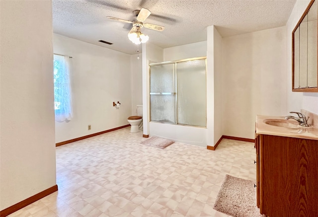 full bathroom featuring a textured ceiling, ceiling fan, vanity, and toilet