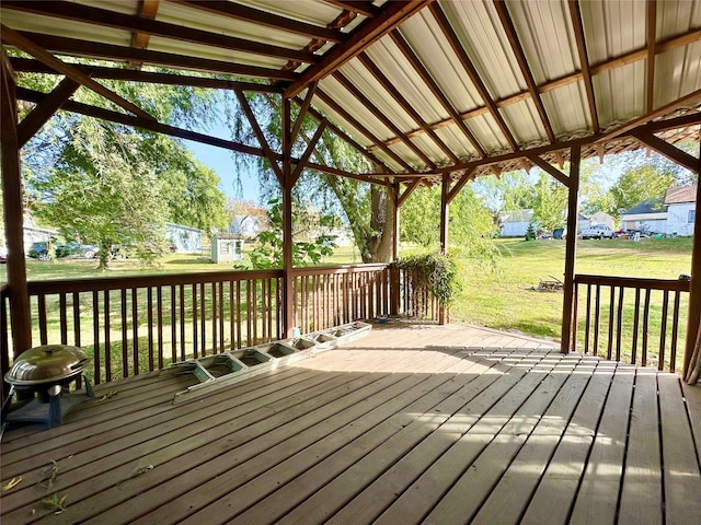 wooden deck featuring a lawn