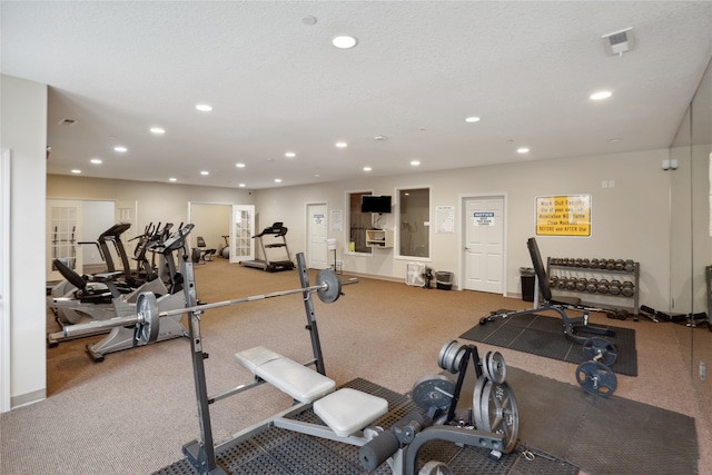 exercise room featuring light colored carpet