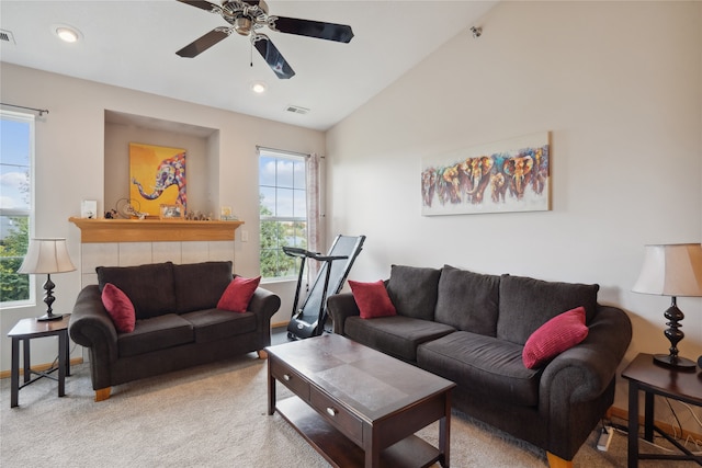 living room featuring a healthy amount of sunlight, vaulted ceiling, and carpet flooring