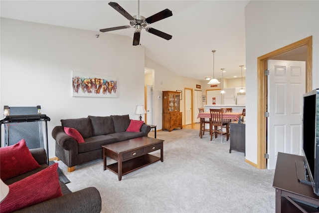 living room featuring high vaulted ceiling, light colored carpet, and ceiling fan