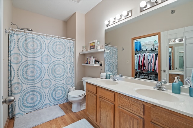 bathroom with a shower with shower curtain, vanity, toilet, and hardwood / wood-style flooring