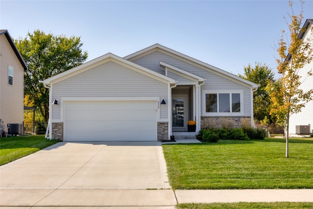 view of front of house featuring a front yard, central AC unit, and a garage