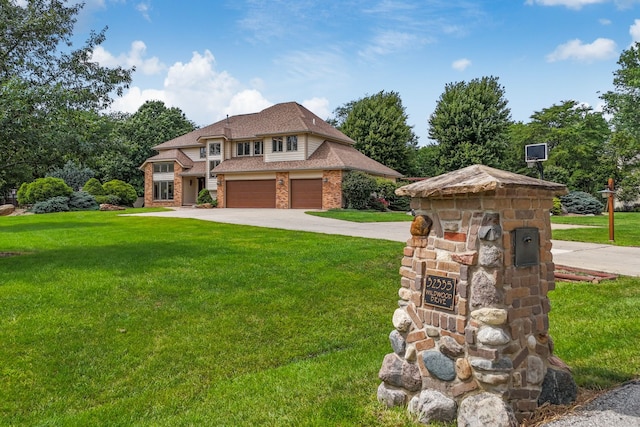 view of front of property with a front lawn and a garage