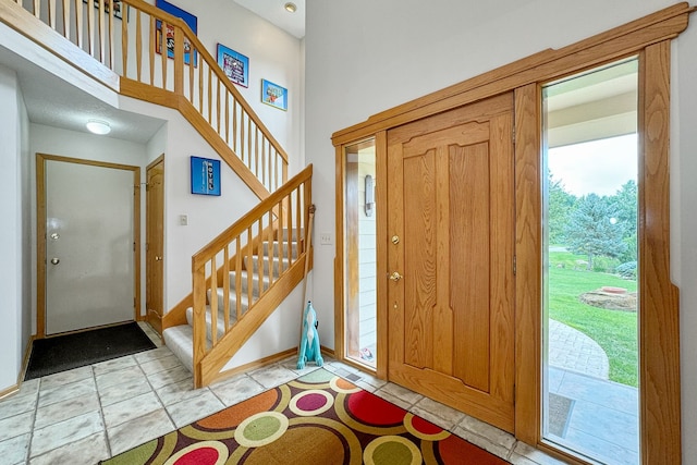 foyer entrance featuring light tile patterned flooring