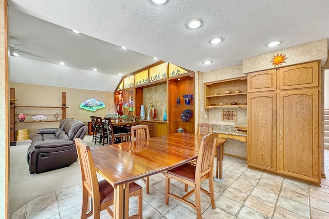 dining room with ceiling fan, ornamental molding, a textured ceiling, and vaulted ceiling