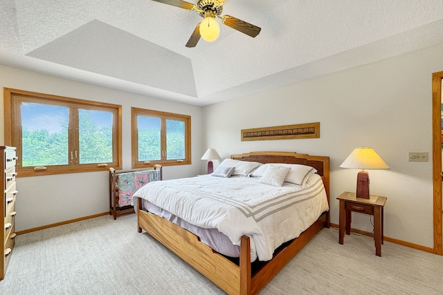 bedroom with a textured ceiling, ceiling fan, and light colored carpet