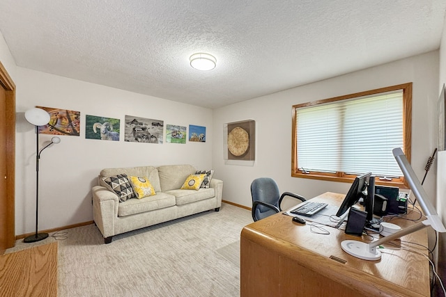 carpeted office featuring a textured ceiling