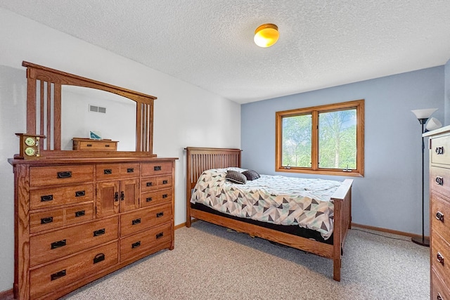 carpeted bedroom featuring a textured ceiling