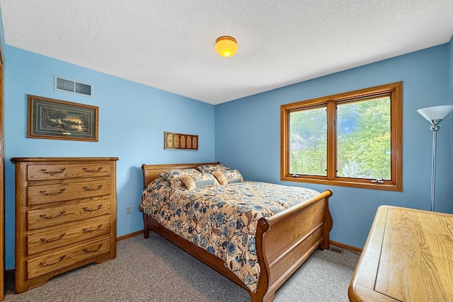 carpeted bedroom featuring a textured ceiling