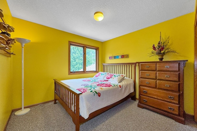 carpeted bedroom featuring a textured ceiling