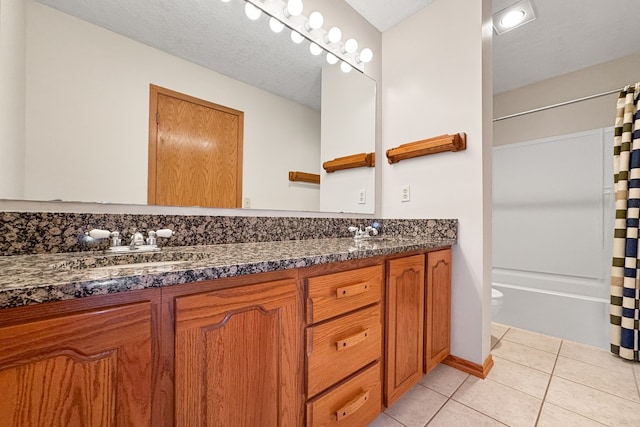 full bathroom with vanity, toilet, shower / bath combo, a textured ceiling, and tile patterned flooring