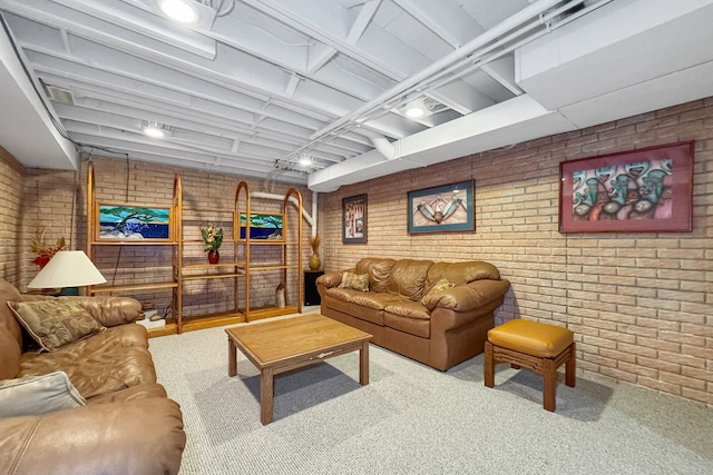 carpeted living room with brick wall