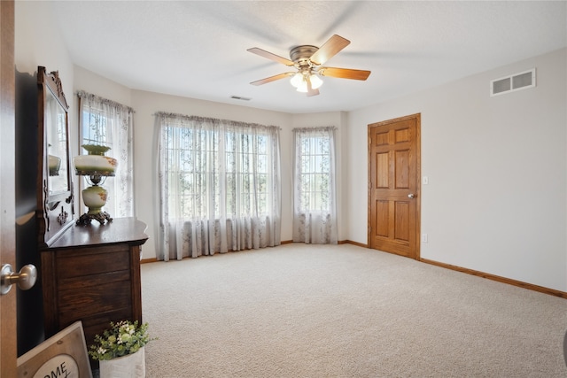 sitting room featuring light carpet and ceiling fan