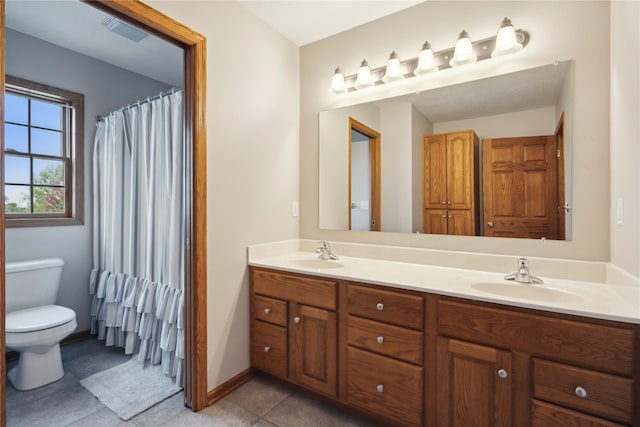 bathroom with vanity, toilet, and tile patterned floors