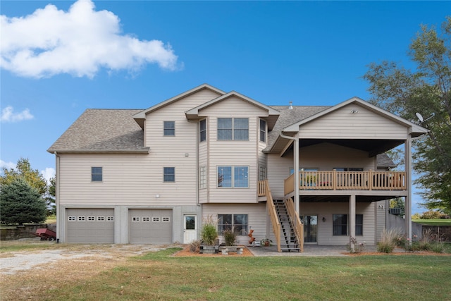 back of property featuring a garage, a wooden deck, and a yard