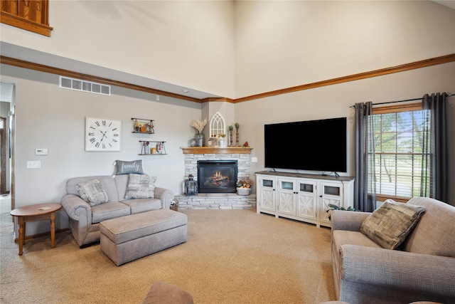 living room featuring a high ceiling, carpet flooring, and a stone fireplace