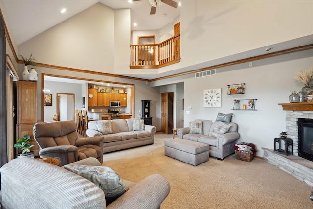 carpeted living room with a fireplace, high vaulted ceiling, and ceiling fan