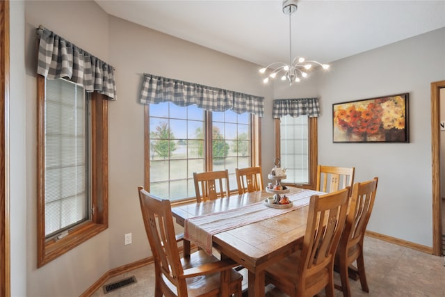 tiled dining space with a chandelier