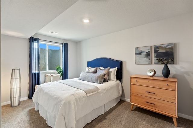 bedroom with dark colored carpet