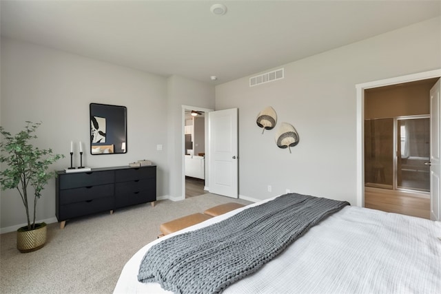 bedroom with carpet floors and connected bathroom