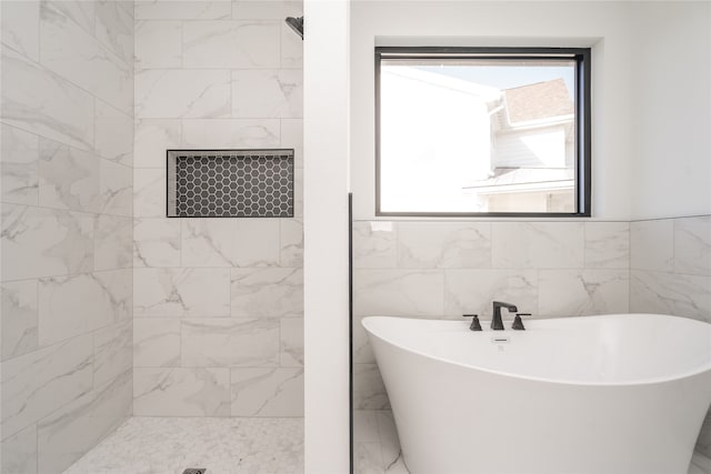 bathroom featuring separate shower and tub and tile walls