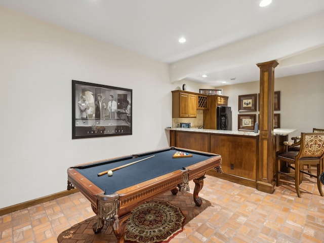 playroom with ornate columns, pool table, and bar