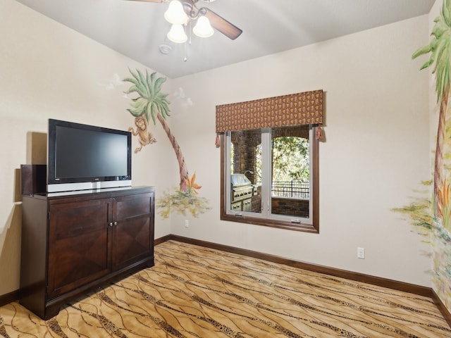 unfurnished living room with ceiling fan