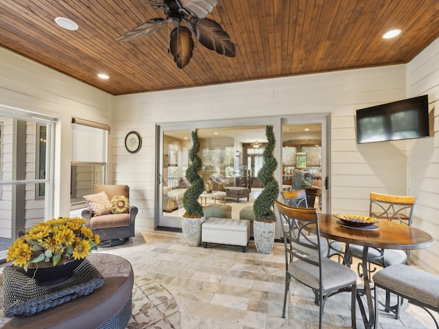 sunroom with ceiling fan and wooden ceiling