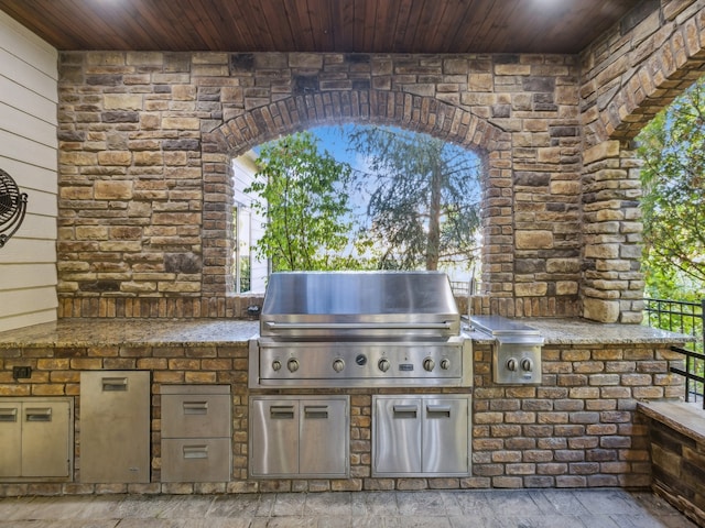 view of patio with area for grilling and an outdoor kitchen