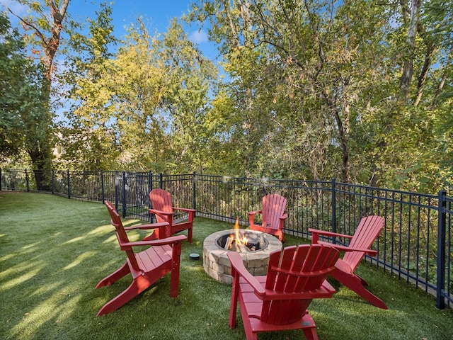 view of playground featuring a fire pit and a lawn