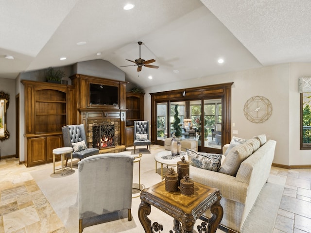 living room featuring ceiling fan, lofted ceiling, and a fireplace