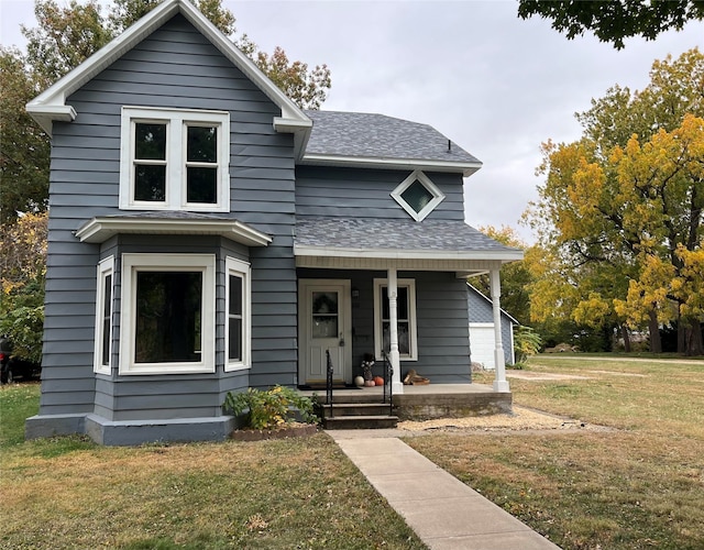 view of front of property with a front yard and covered porch