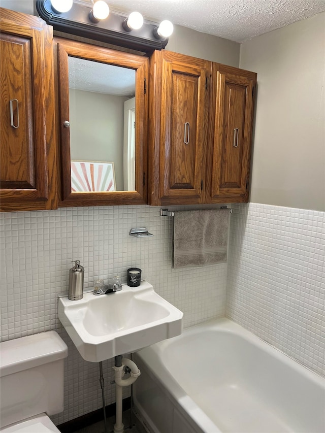 bathroom with a bathtub, toilet, and tile walls