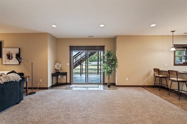 carpeted living room featuring a wealth of natural light