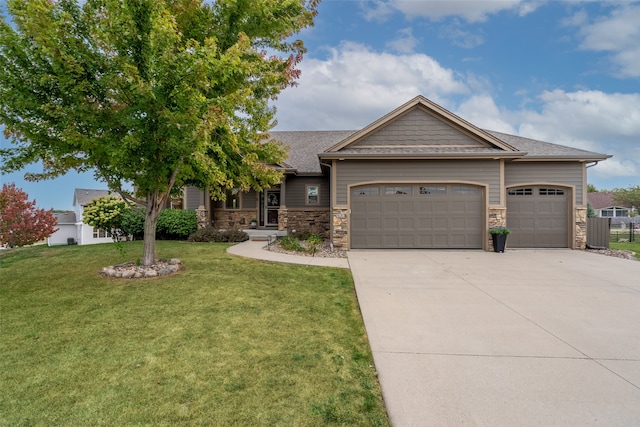 view of front of property featuring a garage and a front lawn