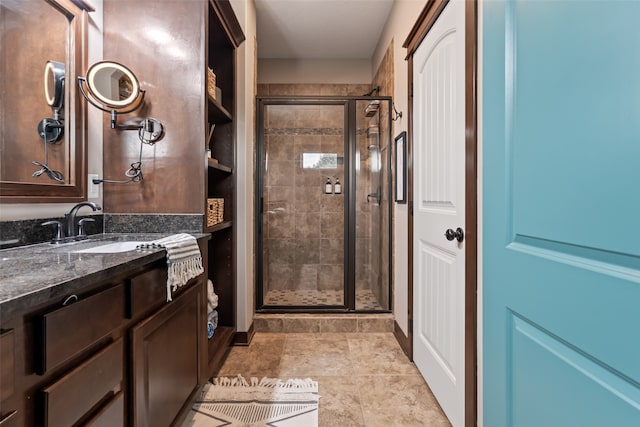 bathroom featuring vanity and a shower with shower door