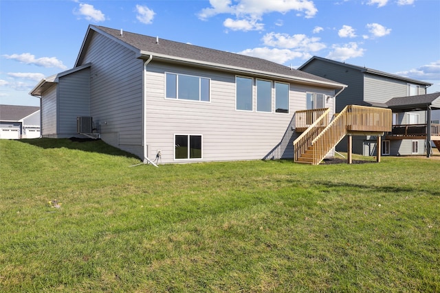 back of house with central AC, a yard, and a deck