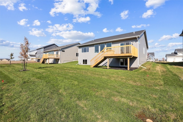 back of house with a wooden deck and a yard