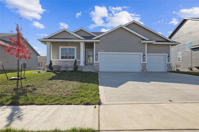 craftsman-style house featuring a garage and a front lawn