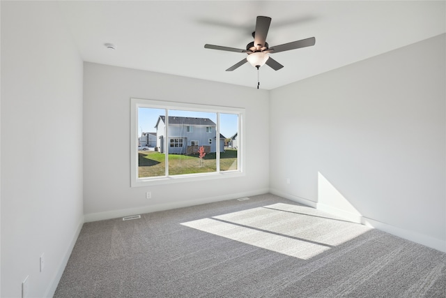 carpeted empty room featuring ceiling fan