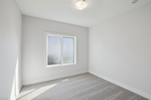 unfurnished room featuring light colored carpet