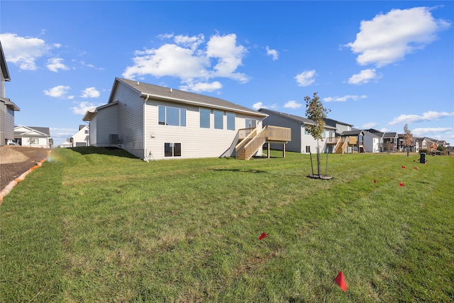 rear view of property featuring a lawn