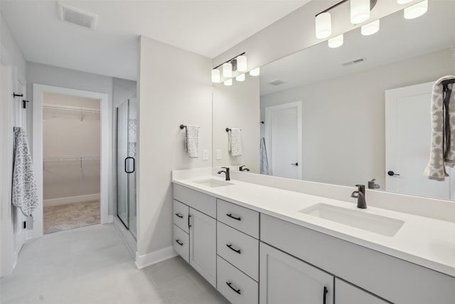 bathroom with vanity and a shower with door