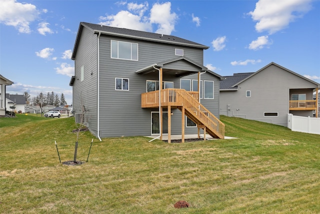 rear view of house featuring a yard and a deck